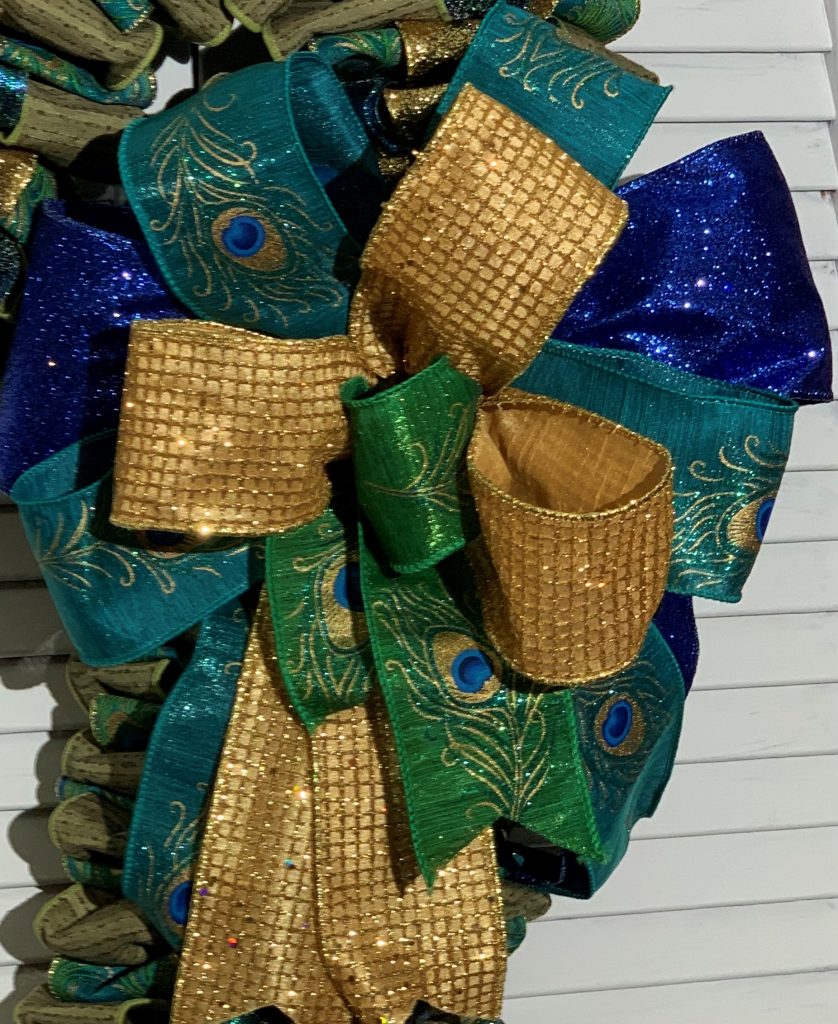 Green and Blue Peacock ribbons and Gold glittered ribbon on a candy cane